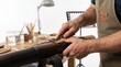 © Stitch - Craftsman carving the mouthpiece of a dark bamboo shakuhachi flute with a sharp curved knife