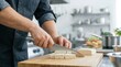 © Stitch - Chef using a large knife to dice firm tofu on a wooden cutting board