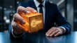 © resky - Digital key access cyber security concept with businessman hand holding glowing golden circuit cube symbolizing network data protection
