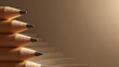 © Siti - Stacked sharpened wooden writing implements resemble a rising staircase against a neutral background