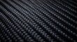 © Muhammad - Close-up shot of a black carbon fiber weave texture revealing glossy strands and repeating pattern, conveying high-tech, durable composite material ideal for automotive, aerospace and industrial.