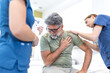 © Graphicroyalty - A concerned nurse and doctor provide care to an older male patient experiencing chest pain on a hospital bed. The team monitors the patient while reviewing medical documentation