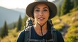 © brocar - Young woman hiker in sun hat with backpack on mountain trail outdoors