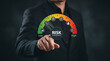 © Top seller  - Businessman pointing at virtual risk management speedometer gauge for compliance evaluation