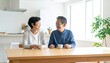 © Yuki - 朝食後に会話を楽しむシニア夫婦