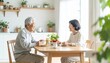 © Yuki - 朝食後に会話を楽しむシニア夫婦