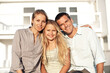 © peopleimages.com - Portrait, smile and family at house with love, connection and bonding at holiday retreat. Happy, people and daughter at accommodation with embrace, weekend break and summer vacation at getaway resort