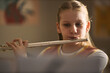 © DragonImages - Caucasian girl playing flute during music lesson, practicing instrument skills and arts education. Useful for school programs, music classes, youth learning campaigns