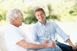 © peopleimages.com - Wine, backyard and man with senior father for bonding, conversation and relax on weekend. Family, outdoor and person with elderly parent, alcohol and drink for connection, relationship and talking
