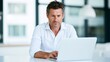 © Bonsales - Mature man focusing on laptop screen in a modern office, working on business project or online learning
