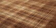© Seyyar - Textured close shot of brown tartan textile with rectangular beige and wood color blocks and parallel linear details