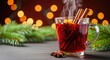 © Hugnaka - Steaming red mulled wine in a glass mug with cinnamon sticks and star anise, set against a background of warm bokeh lights and pine branches, christmas, traditional, atmosphere