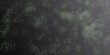 © Patrick Tappe - Abstract dark textured background with green scattered speckled particles creating an organic grunge surface. Gradient transitions from dense, dark detail on the left to green tones