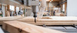 © MaksymFilipchuk - CNC woodworking machine cutting timber panels in modern carpentry workshop with precision milling