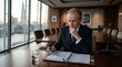 © Celso Pupo - Senior business executive reviewing documents in a modern boardroom during a strategic decision-making process