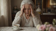 © Alexey - Senior woman with memory loss feeling stressed and confused while sitting at home. Elderly lady suffering from dementia or Alzheimer disease. Mental health awareness and aging concept.