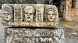 © fotoworld - Ancient carved stone theater masks in weathered ruins with soft natural light, perfect for travel editorial, history features, heritage marketing, 5 May 2026 Subitica, Serbia