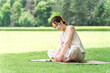 © buritora - Moms, mothers, and young Asian women doing baby yoga and parent-child yoga (in yoga wear, in the park)