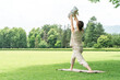 © buritora - Moms, mothers, and young Asian women doing baby yoga and parent-child yoga.