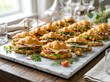 © GlobalPixel Studio - Fresh mini croissant sandwiches with turkey and vegetables on a stone serving board in a kitchen. Sandwich appetizer ideas