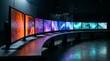 © Syeda - Curved computer monitors colorful screens on a desk in a dark room curved desk technology