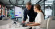 © Andrey Popov - Two Financial Analysts Are Reviewing Data And Performance
