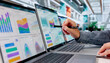 © Andrey Popov - Experienced Financial Analyst Reviewing Multiple KPI Dashboards