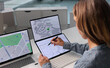 © Andrey Popov - Experienced Woman Examines City Land Plots On Computer Screen
