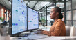 © Andrey Popov - Young African Business Analyst Studies Digital Workflow Dashboard