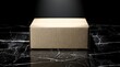© DARA - A plain cardboard box sits on a dark marble surface.