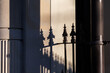 © Austockphoto - Shadow of wrought iron fence on brick column
