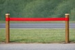 © Fotograf - A red ribbon tied to a wooden post, suitable for decorative or memorial purposes
