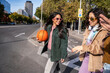 © ADDICTIVE STOCK - Gen-Z women friends walking in city with basketball