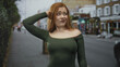 © Krakenimages.com - Woman shrugs shoulders with palms up on a street showing bare shoulders and a puzzled face; confusion.