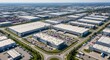 © Liew - Sprawling industrial logistics complex with numerous warehouses and distribution centers under a clear blue sky.