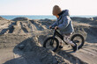 © Lika/Stocksy - A Toddler Rolling In The Sand By The Sea