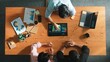© InfiniteFlow - Top aerial view of business man present financial graph to group of smart investors. Professional male leader analyze graph and explain marketing idea by using tablet on meeting table. Convocation.