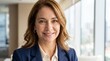 © Syed - Headshot close up portrait of confident mature European business woman smiling at camera. Middle aged Latin hispanic 40s businesswoman leader mentor manager in office background, copy space