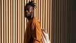 © Andrii Zastrozhnov - Stylish young man portrait in rust jacket with canvas backpack against corrugated wall for urban background and banner design
