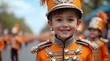 © Nataliya - Young boy in an orange uniform smiling for the camera, active child player youth portrait happy emotion school team kid student human person lifestyle