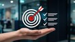 © Isabella - Hand holding holographic target icon with arrow hitting bullseye, checklist for success, strategic planning and goal achievement concept in corporate environment background.
