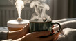 © Gexz - Woman holding steaming cup on a cozy morning