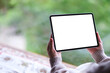© Farknot Architect - Mockup image of a woman holding tablet with blank desktop white screen on the bed at home
