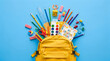 © stock by siam - Yellow School Backpack Overflowing with Stationery and Art Supplies on a Blue Background.