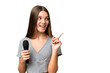 © luismolinero - Teenager singer girl picking up a microphone over isolated background intending to realizes the solution while lifting a finger up