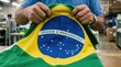 © MstTanjina - Brazilian flag being held by a person in a warehouse