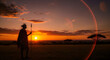 © MdEkhlus - Maasai warrior silhouette standing in African savanna at sunset