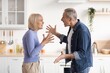 © Prostock-studio - Frustrated Elderly Caucasian Man And Woman Arguing With Each Other In Kitchen, Showing Emotion And Discontent. Conflict Arising Between Mature Couple In Domestic Setting Over Disagreement.