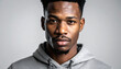 © tata - Portrait of a serious young African American man wearing a grey hoodie looking at camera.