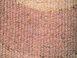 © Vector Vertor - Close-up of a rustic woven natural fiber rug texture